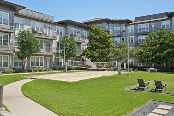 Courtyard with volleyball court and outdoor lounge seating